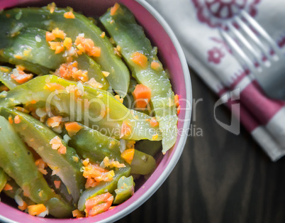 Marinated cucumbers with carrots and spices.