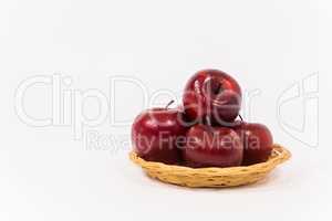 Ripe red apples in wicker basket isolated on white background