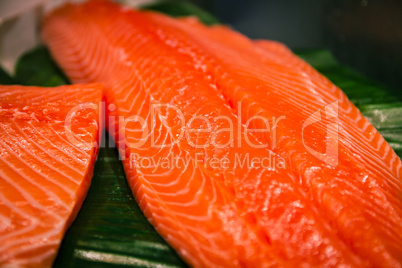 Sliced salmon laid on a green surface