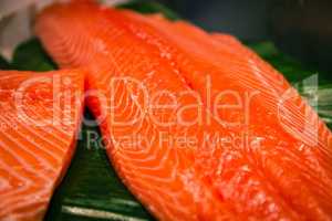 Sliced salmon laid on a green surface