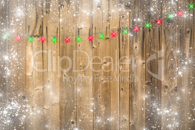 Wooden Background with Christmas Lights and Snowy Border