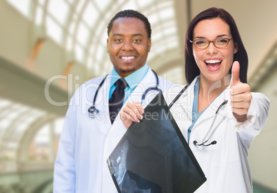 Female and Male Caucasian and African American Doctors in Hospit