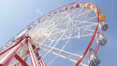 Brightly colored ferris wheel against the blue sky