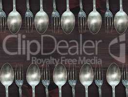 Wooden background with vintage spoons and forks