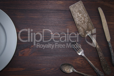 Vintage cutlery on brown wooden surface