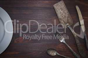 Vintage cutlery on brown wooden surface