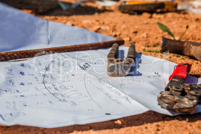 Construction plan and tools laid on the ground