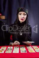 Sorceress wonders by Tarot cards