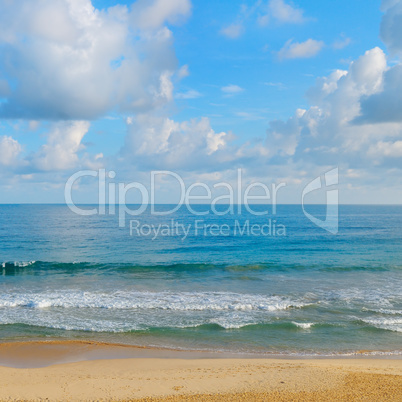 ocean, sandy beach and blue sky