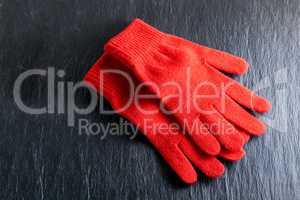 Red gloves on black background