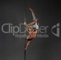 Male dancer at pylon in pole dance studio