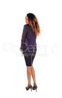 Tall slim woman standing from back.