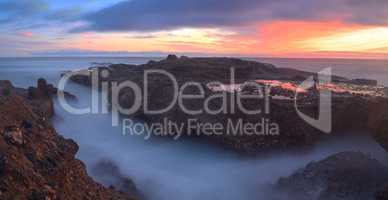 Long exposure of sunset over rocks