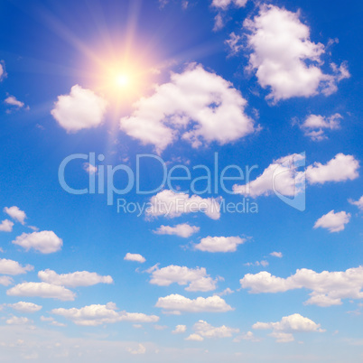 sun on blue sky with white clouds