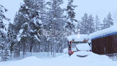 Snow-Covered Tractor in the Winter Forest and Snowfall