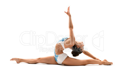 Young female gymnast doing side splits in profile