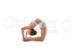 Young female gymnast bending gracefully backwards