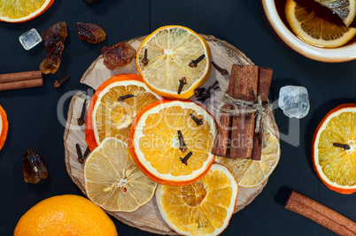 Dried slices of citrus fruits on a wooden surface black