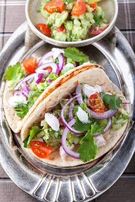 Chicken Tacos with vegetables on a pad