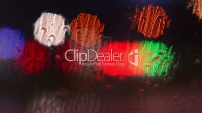Blurred street lights through wet glass