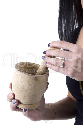 Wooden mortar in female hands