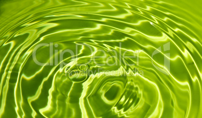 Waves on a surface of green water.