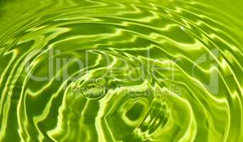 Waves on a surface of green water.