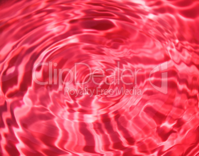 Waves on a surface of red water.