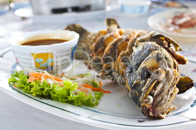 Fried fish with thai spicy seafood sauce.