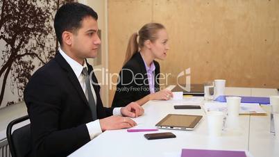 Business people in meeting exchanging business cards