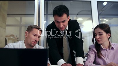 Serious businessman explaining plan to colleagues