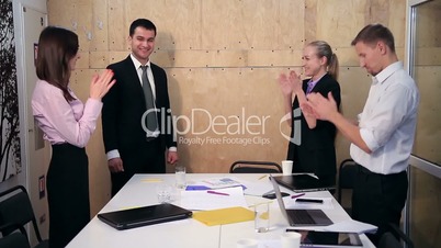 Satisfied proud business team clapping hands