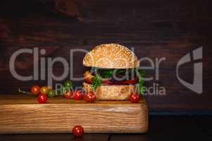 Beef Burger with cutlet and vegetables served on a chopping boar