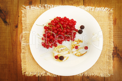 cheese cakes with berries of red currant