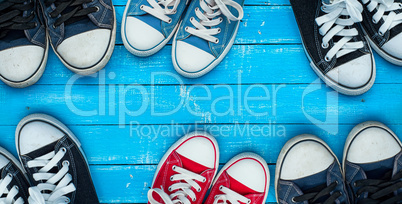 wearing sneakers on a blue wooden surface, top view