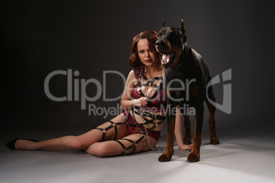Sexy girl in lingerie sitting near dog in studio