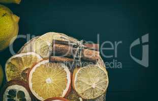 Citrus and cinnamon on the black wooden background
