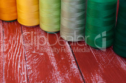 Several of colored spools of thread