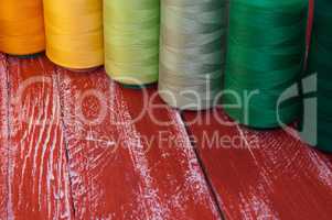 Several of colored spools of thread