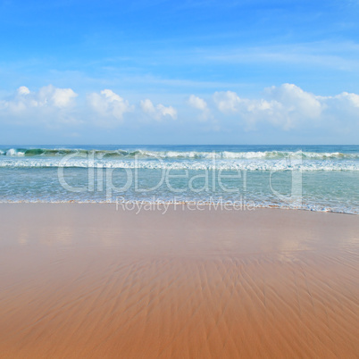 ocean, sandy beach and blue sky