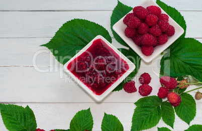 Raspberry jam and fresh raspberries ripe in the saucer