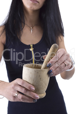 Wooden mortar in female hands