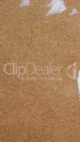 Brown corrugated cardboard background with ripped label - vertic