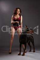 Sexy brunette in undewear with angry dog on leash