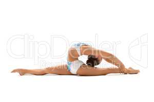 Young female gymnast stretching on white
