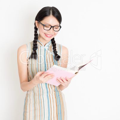 Oriental girl reading book