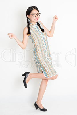 Excited Asian woman jumping around