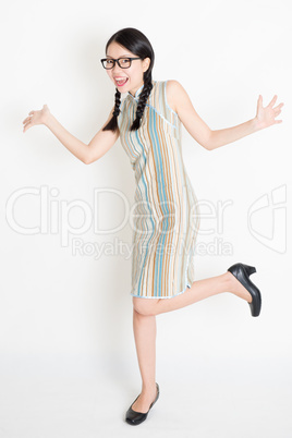 Excited Asian girl jumping around
