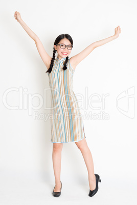 Excited Asian woman arms outstretched