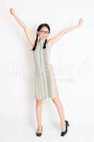 Excited Asian woman arms outstretched